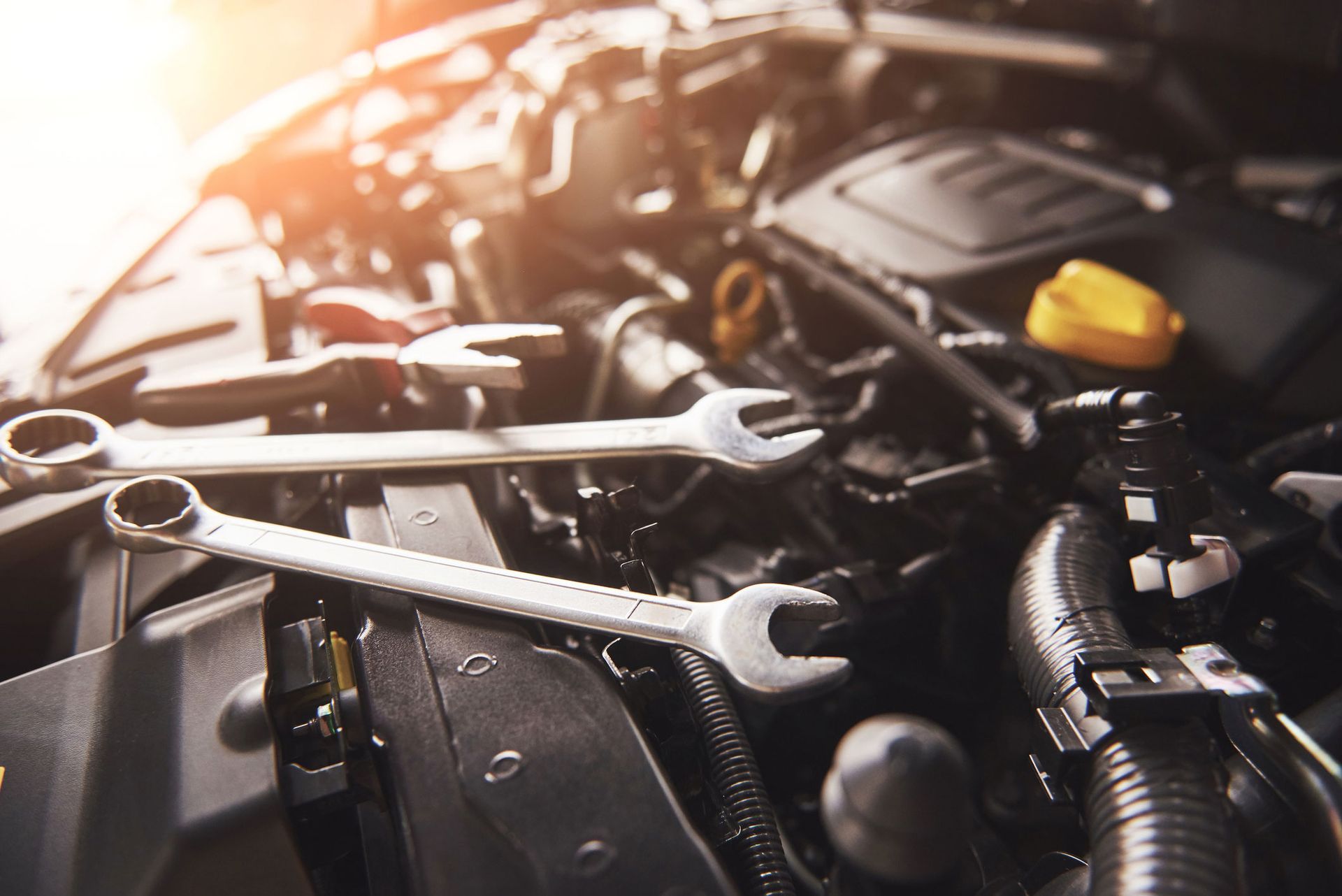 Wrenches resting on a car engine